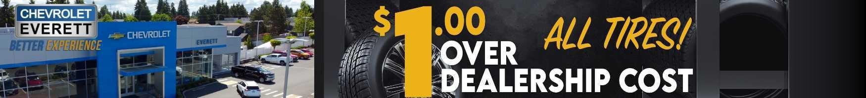 A sign promoting tires and a car dealership, featuring vibrant colors and clear text to attract potential customers.