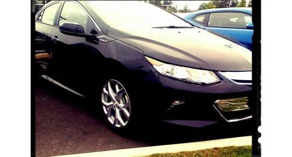 A black Chevrolet Volt parked in a parking lot, showcasing its sleek design and modern features.