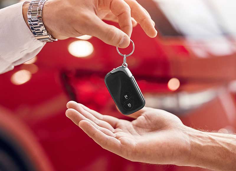 A man transfers a car key to another person